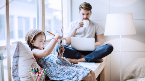 Father and child sitting on a sofa